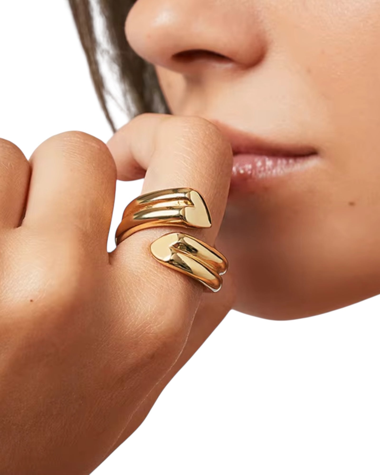 Close-up of a hand wearing two gold rings with a blurred background