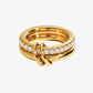 Gold ring with diamond accents on a white background