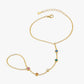 Gold bracelet with gemstones on a white background