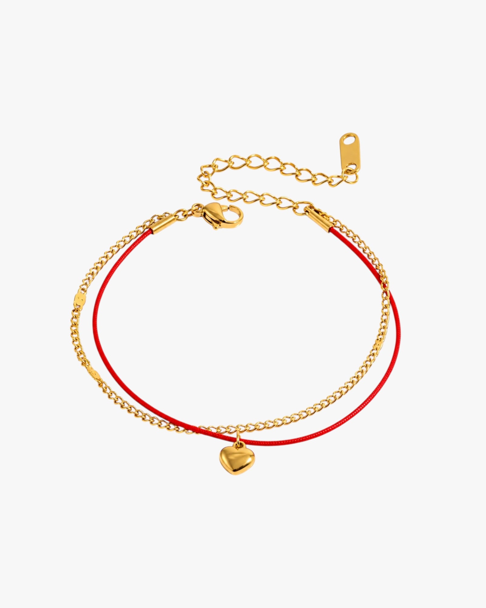 Gold bracelet with a heart charm on a red cord against a white background