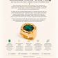 Gold ring with emerald stone on a white background