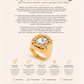 Gold crystal statement ring with product details on a white background