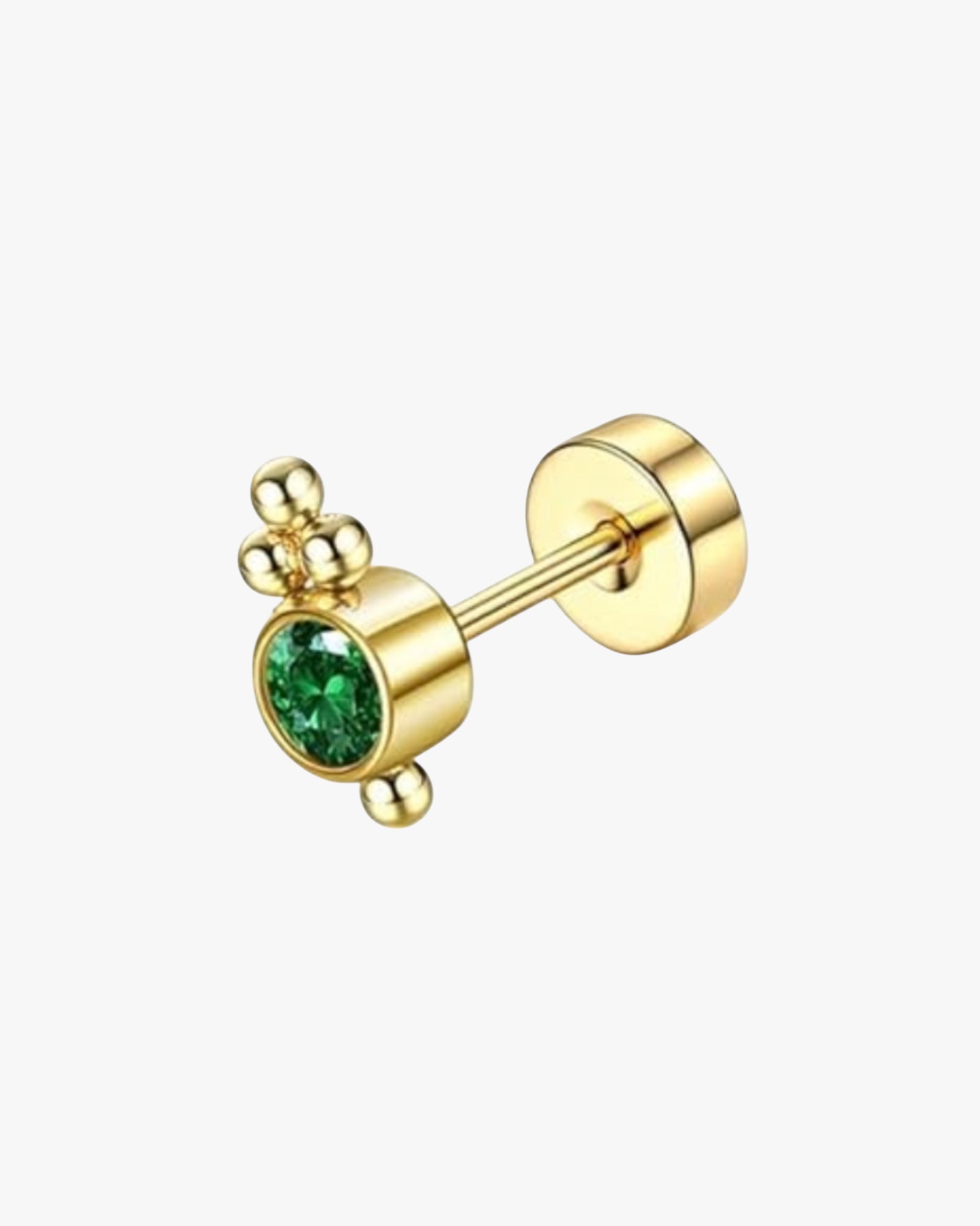 A single gold-colored stud earring with a small green gemstone.