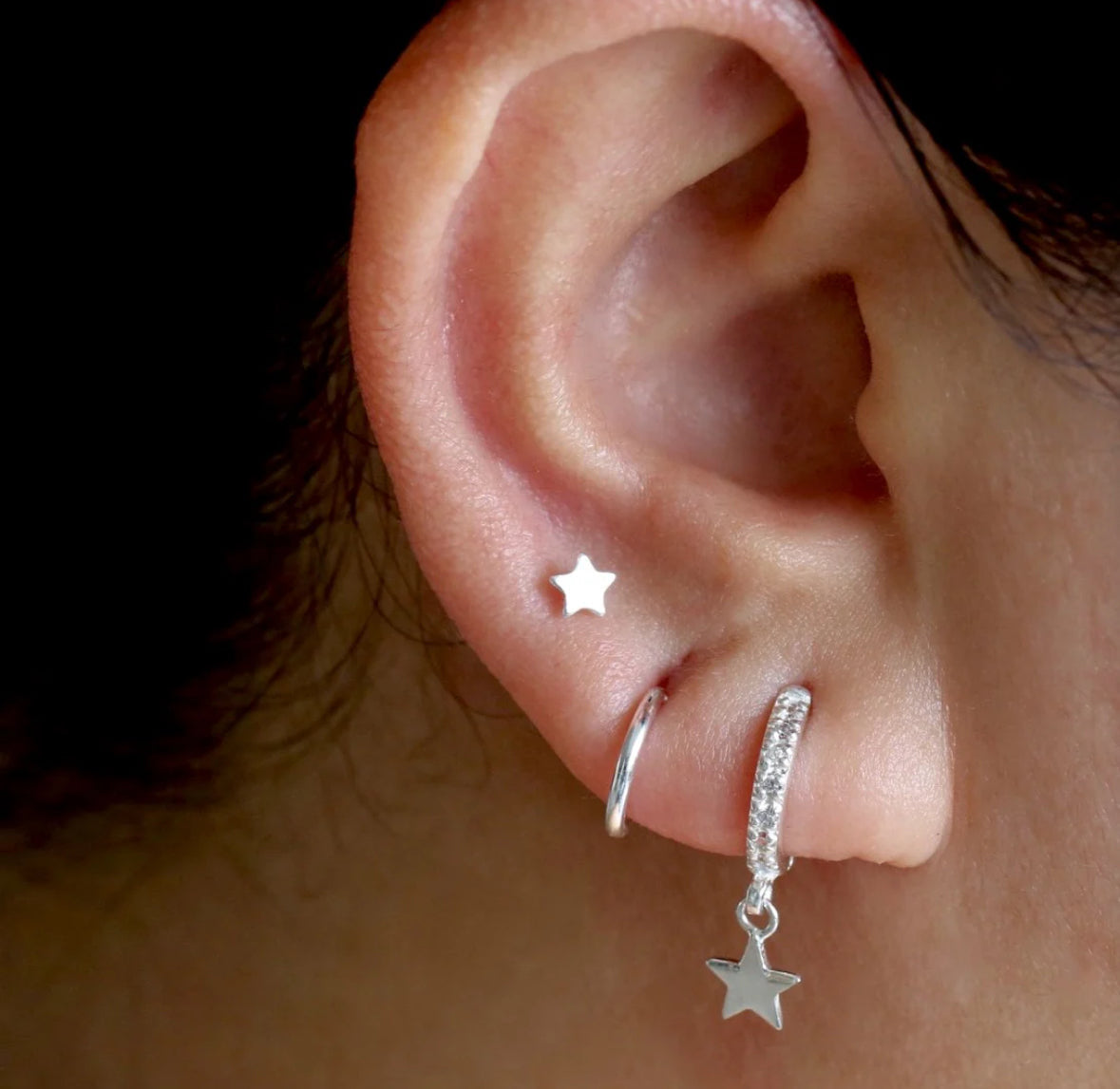 silver color star shapped stud in ear