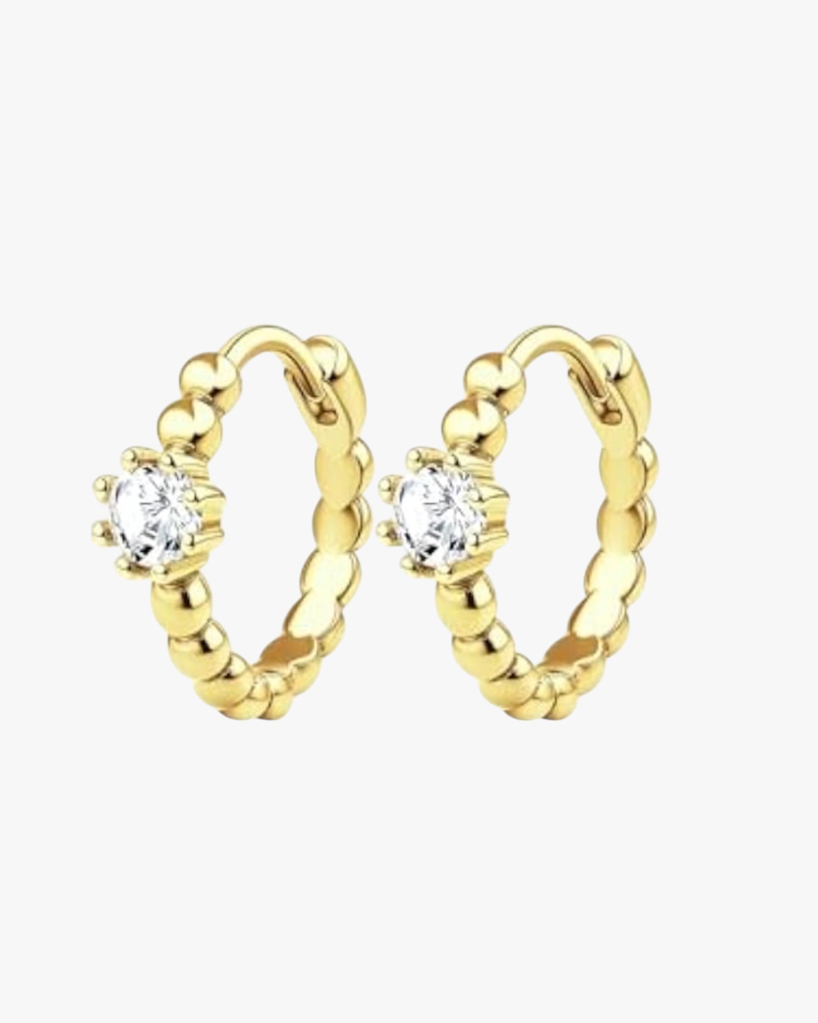 A pair of gold-colored hoop earrings with a small circular embellishment at the top, displayed against a white background.