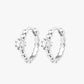 A pair of silver-colored hoop earrings with a small circular embellishment at the top, displayed against a white background.