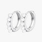 A pair of silver-colored hoop earrings with pearl accents
