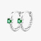 A pair of silver-colored hoop earrings with green gemstones, crafted from 14K gold plated stainless steel.