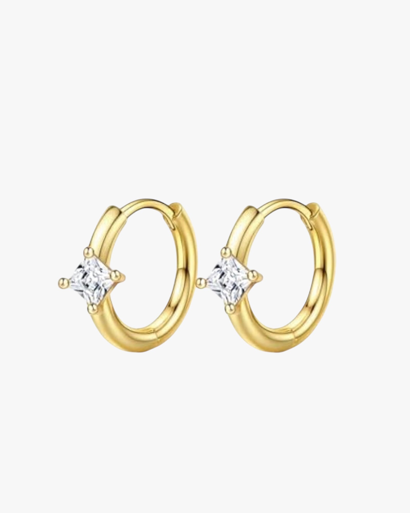 A pair of gold-colored hoop earrings with a small clear crystal in the center.