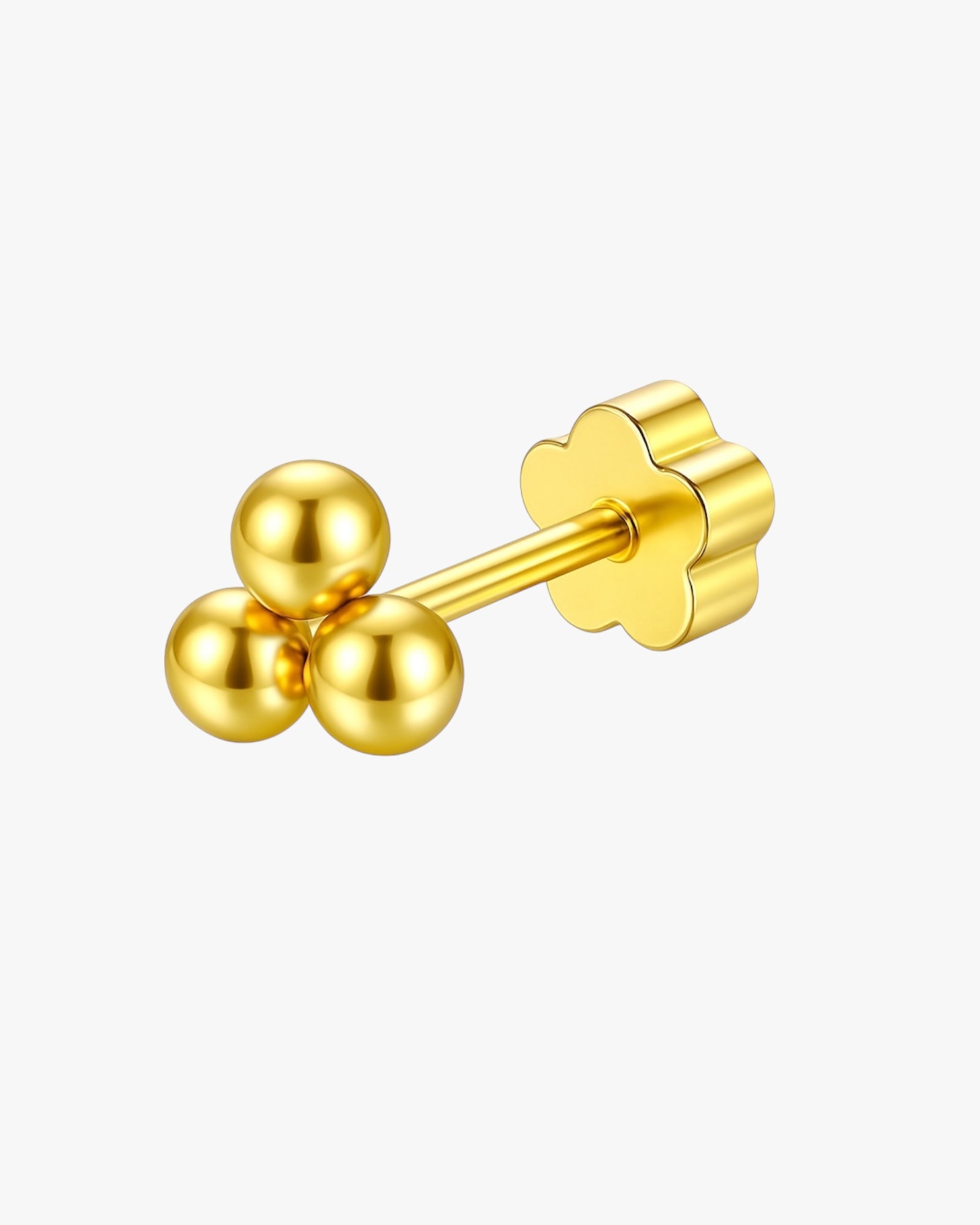 Gold earring with three spherical components on a white background