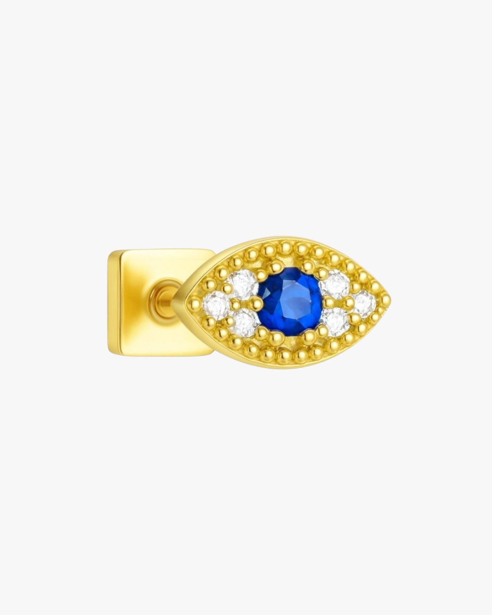 Gold earring with a blue gemstone and clear stones on a white background