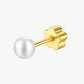 Gold earring with a white pearl on a white background