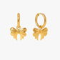 Gold bow-shaped earrings on a white background