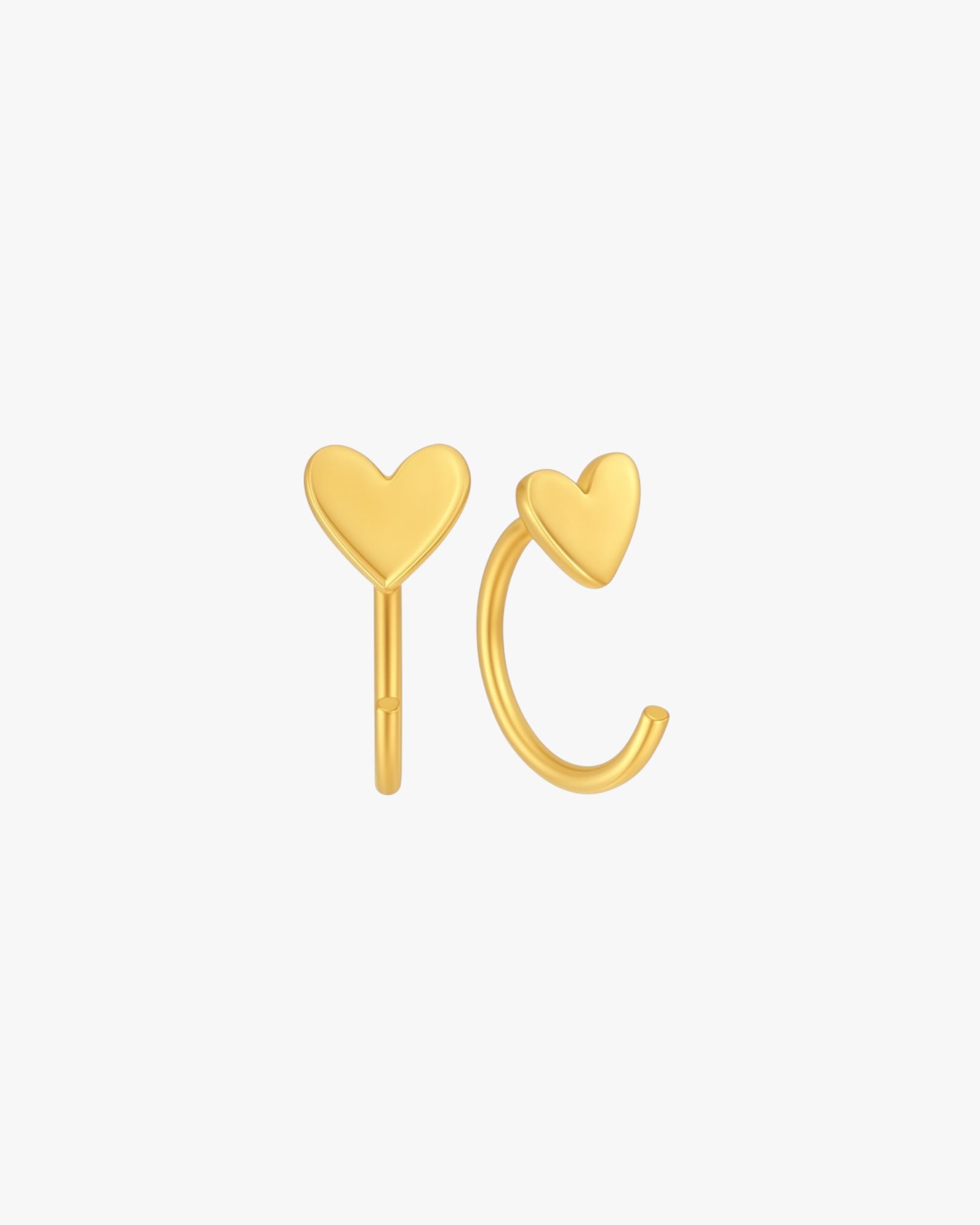 Gold heart-shaped earrings on a white background