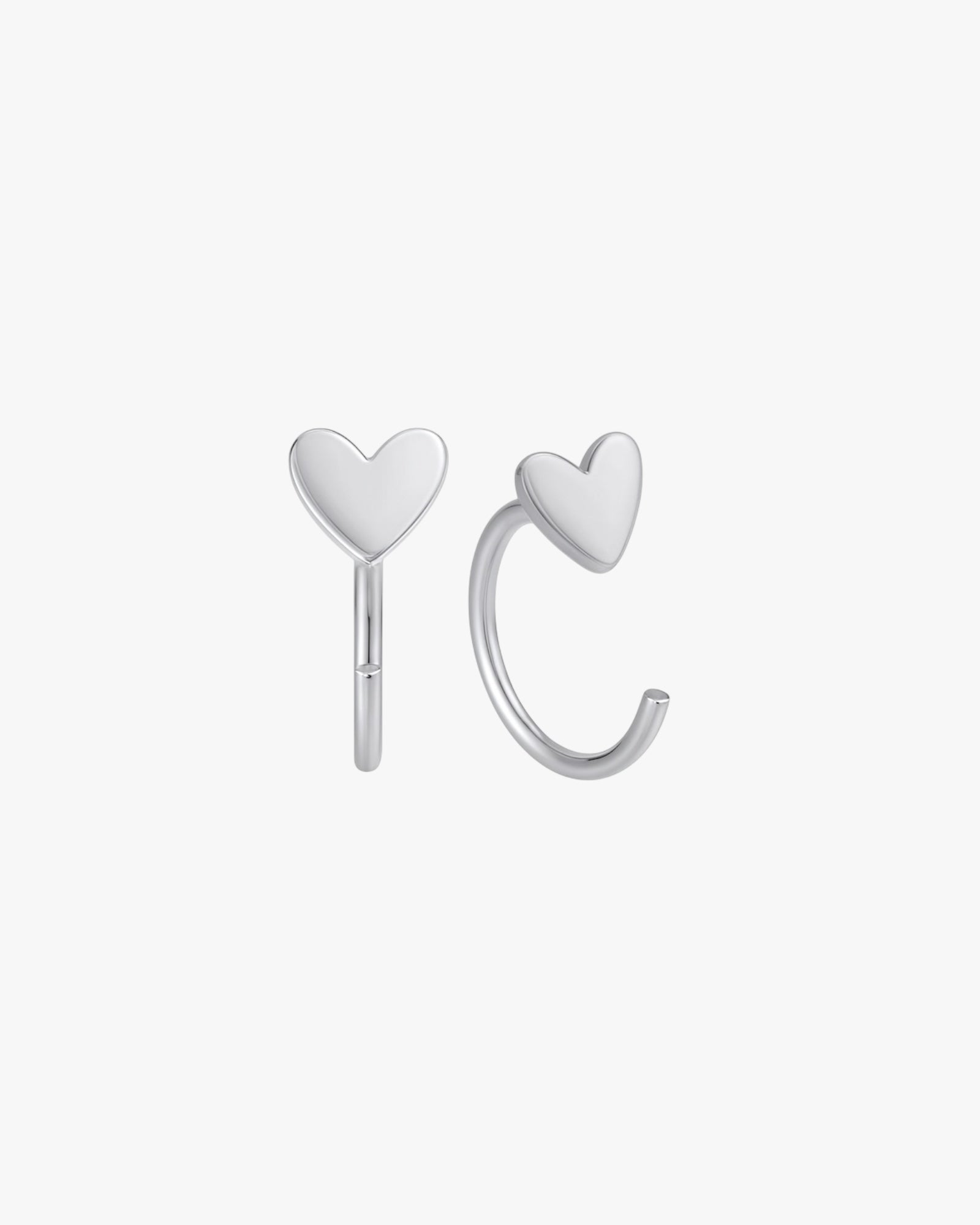 Heart-shaped silver earrings on a white background