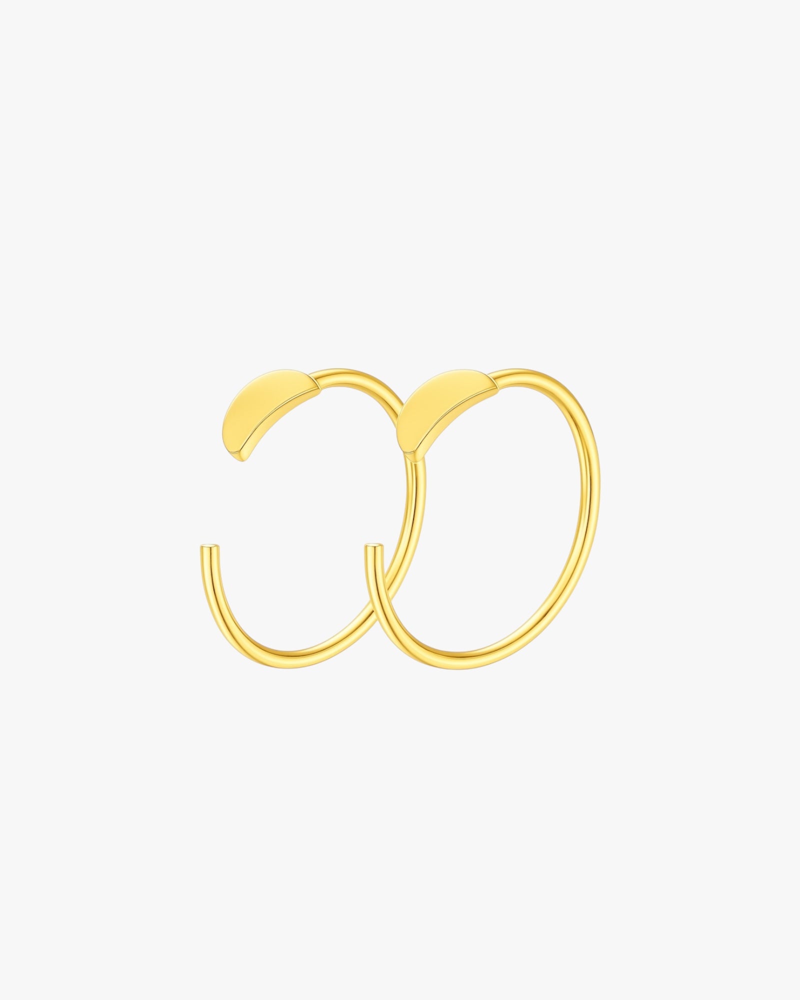 Gold hoop earrings on a light gray background
