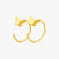 Gold butterfly hoop earrings on a white background