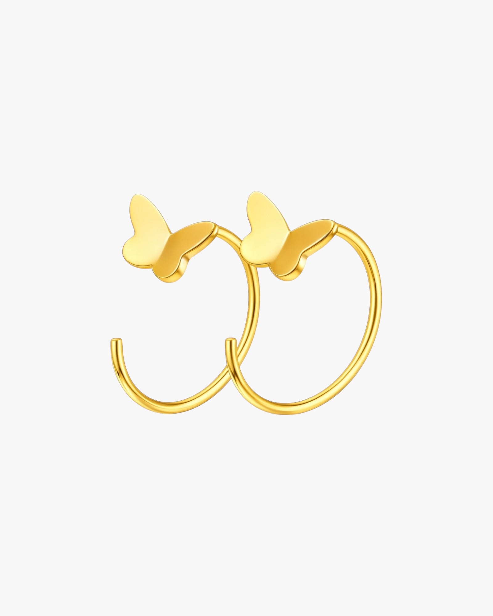 Gold butterfly hoop earrings on a white background