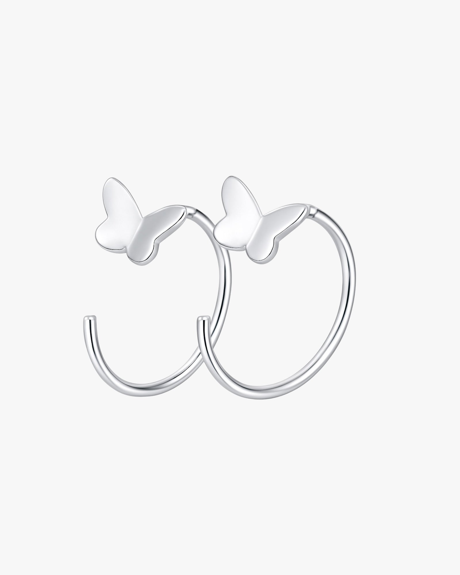 Silver hoop earrings with butterfly accents on a white background
