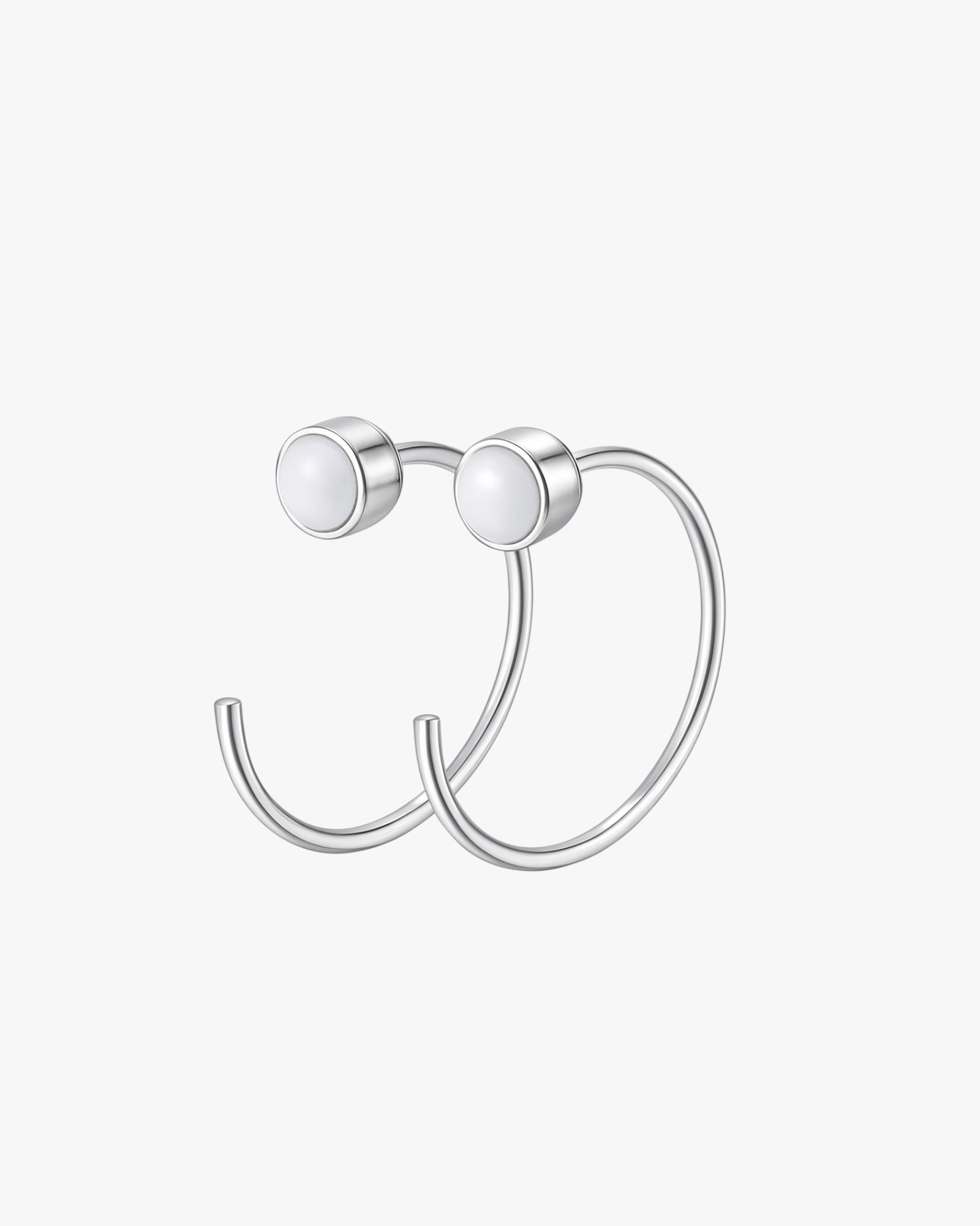Silver hoop earring on a light gray background