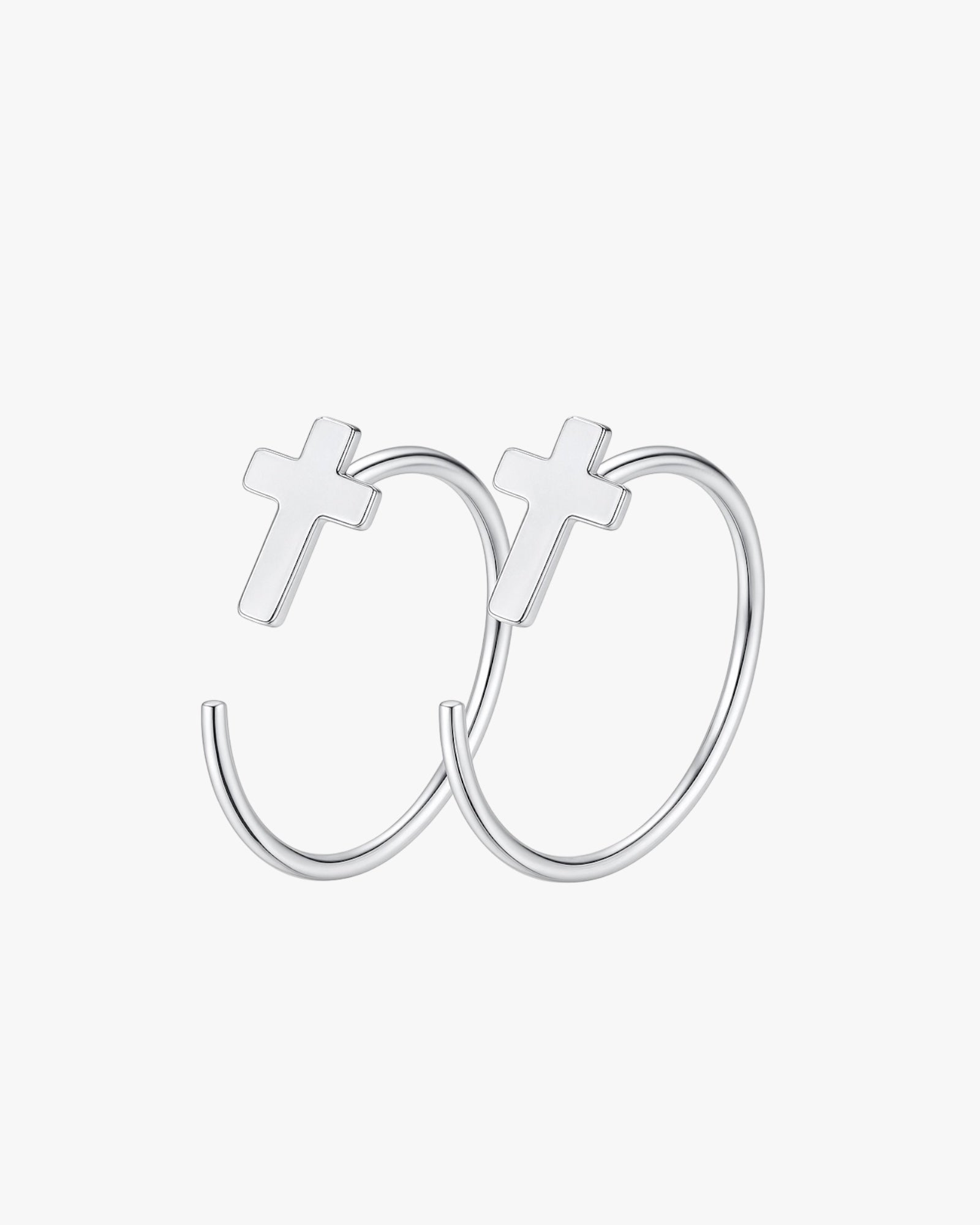 Silver hoop earrings with cross designs on a white background