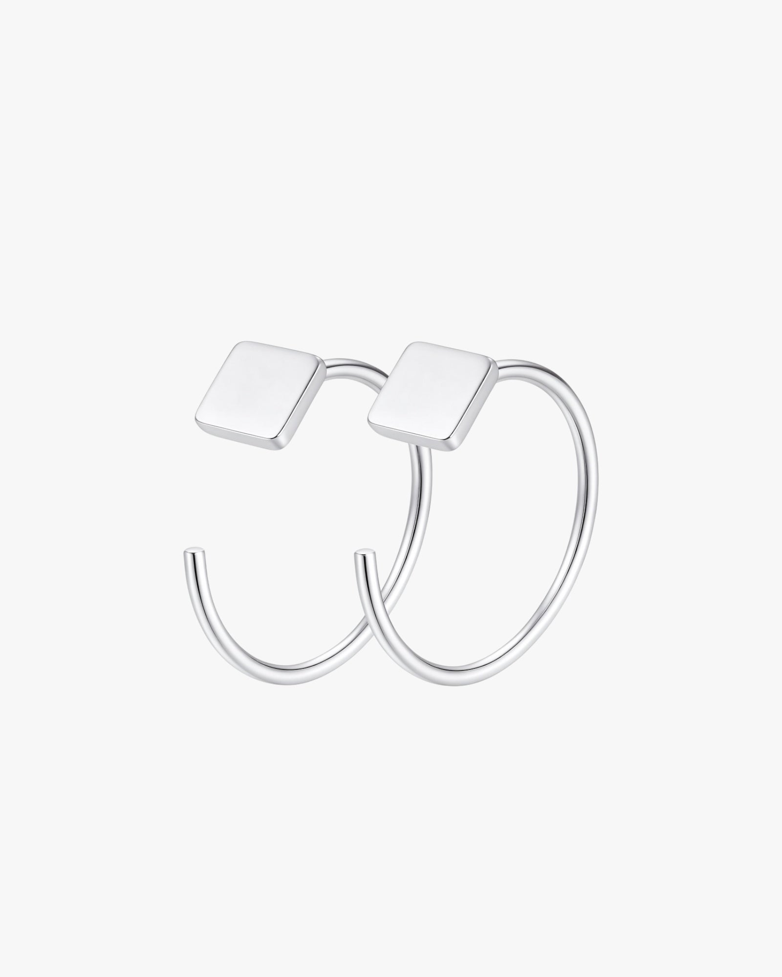 Silver hoop earrings with square tops on a white background