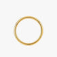 Gold hoop earring on a white background