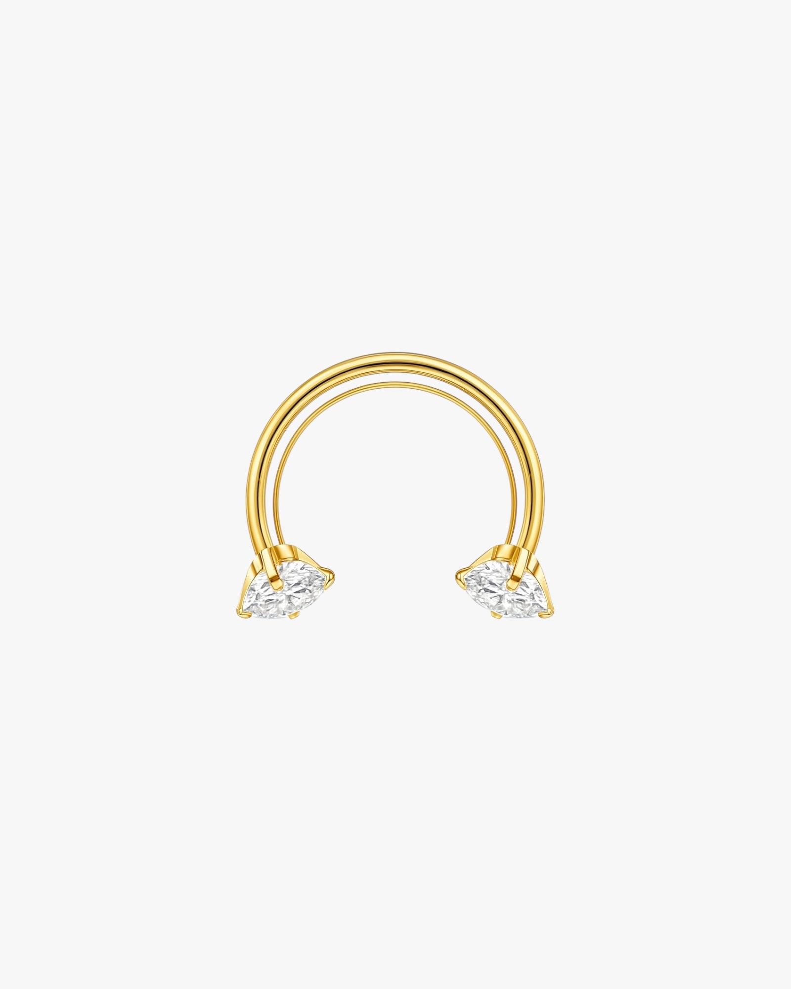 Gold half ring with two clear gemstones on a white background