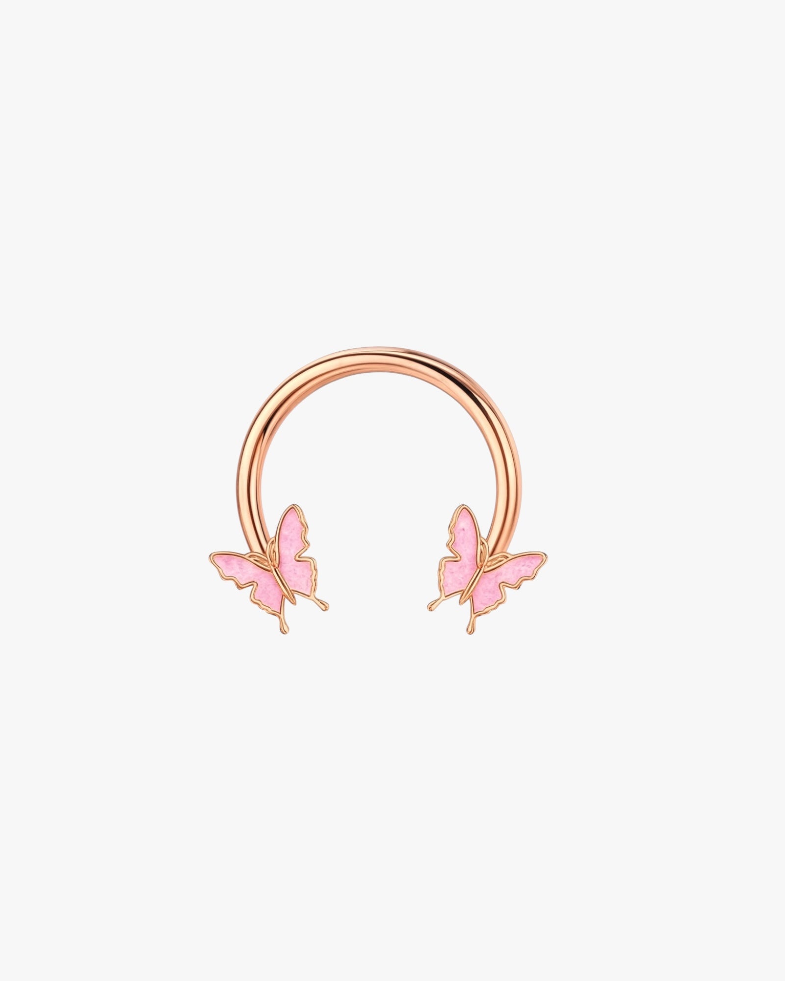 Rose gold half hoop with pink butterfly charms on a light pink background