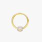 Gold hoop earring with a clear gemstone on a white background