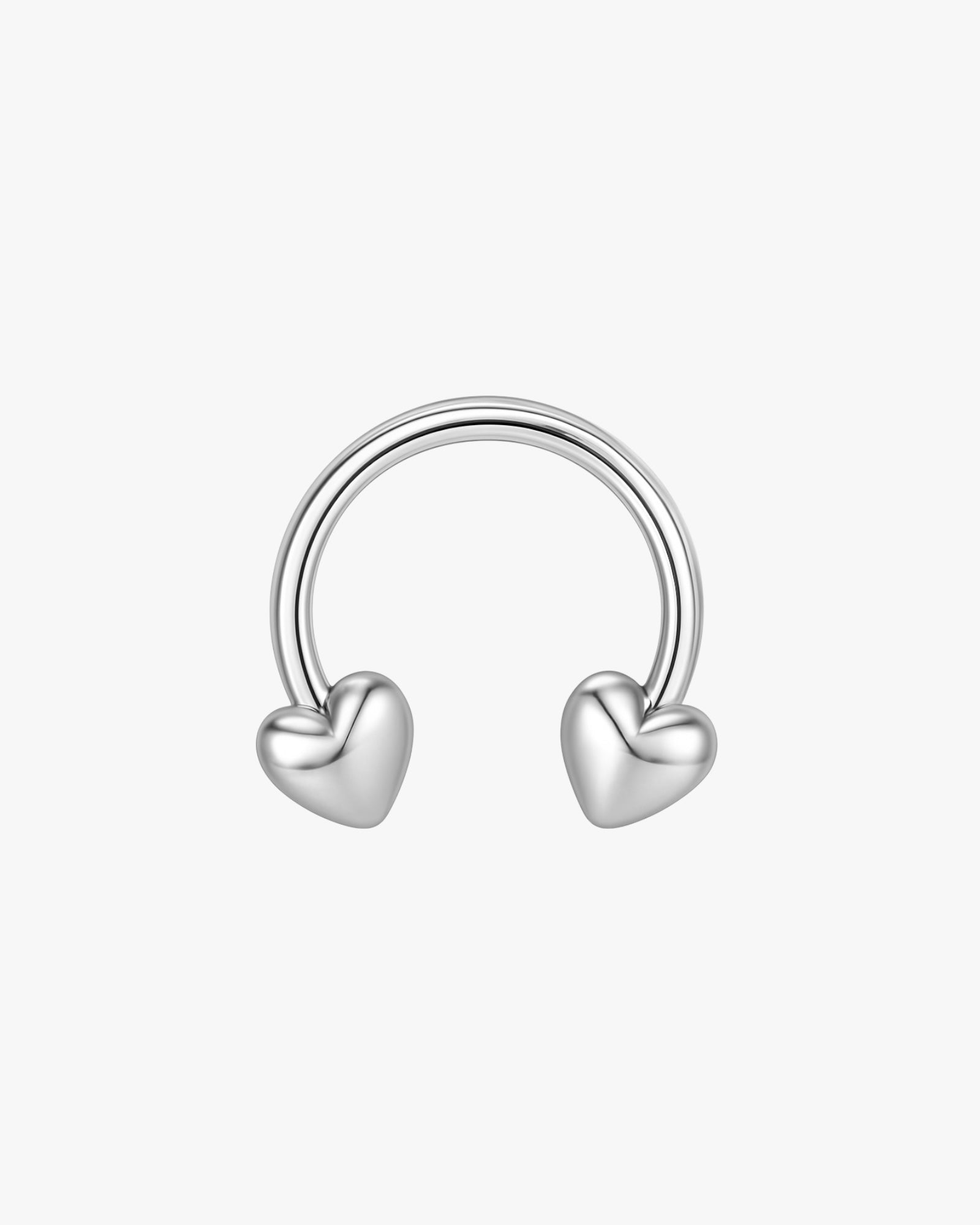 Silver hoop earring with heart-shaped ends on a white background