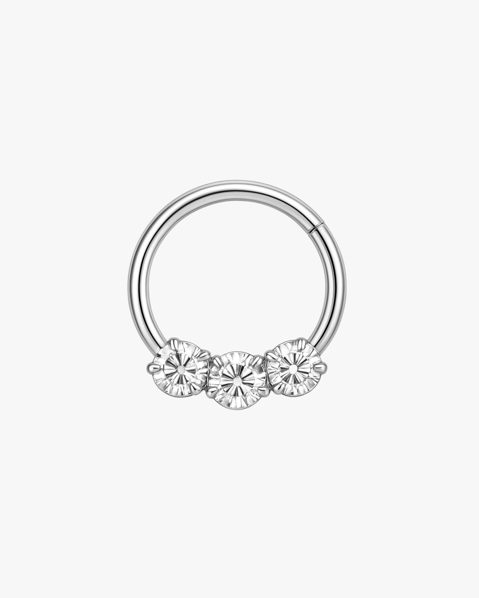 Silver nose ring with three clear gemstones on a white background