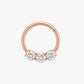 Rose gold nose ring with three clear gemstones on a white background