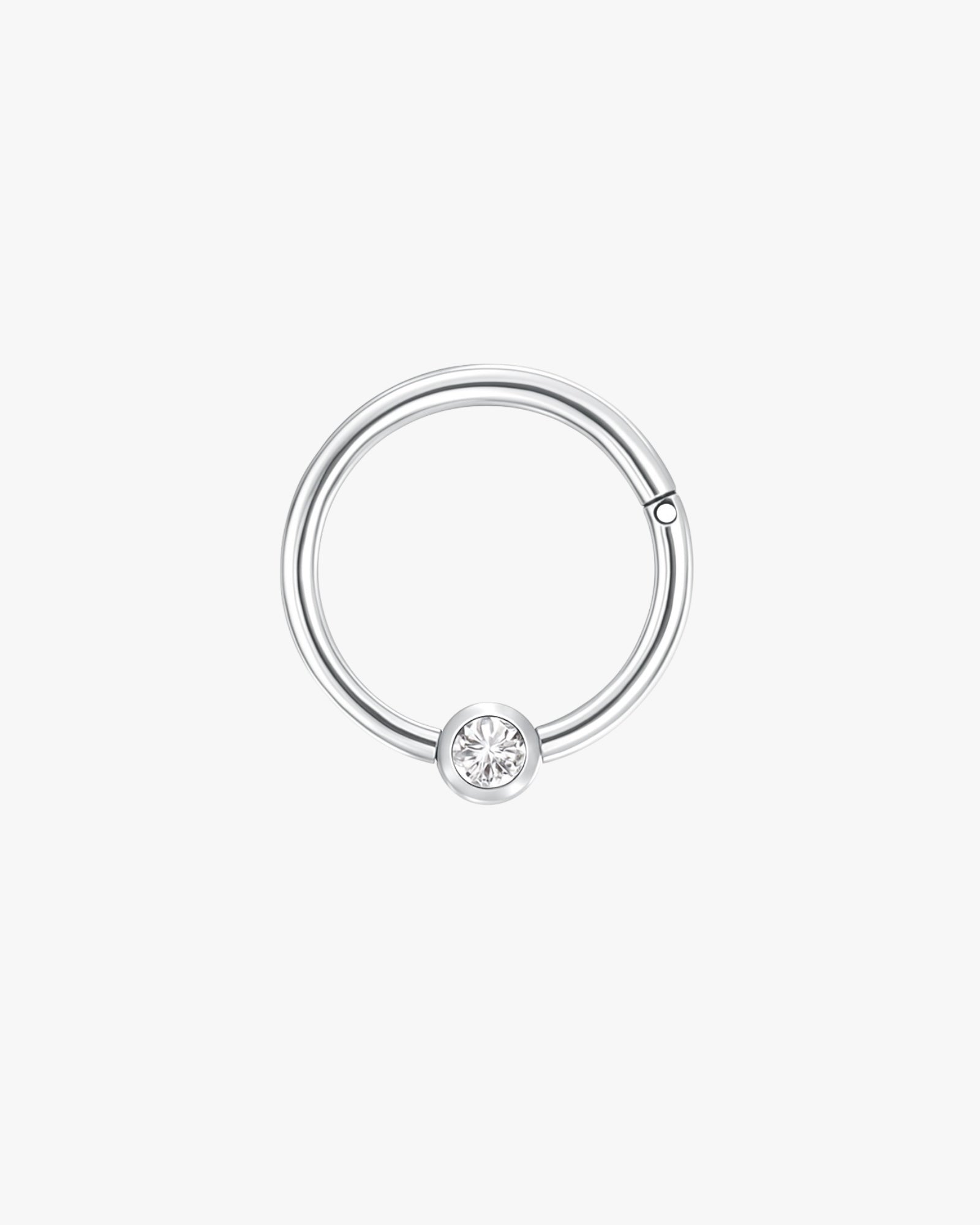 Silver ring with a diamond on a white background