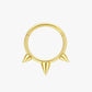 Gold septum ring with spike design on a white background