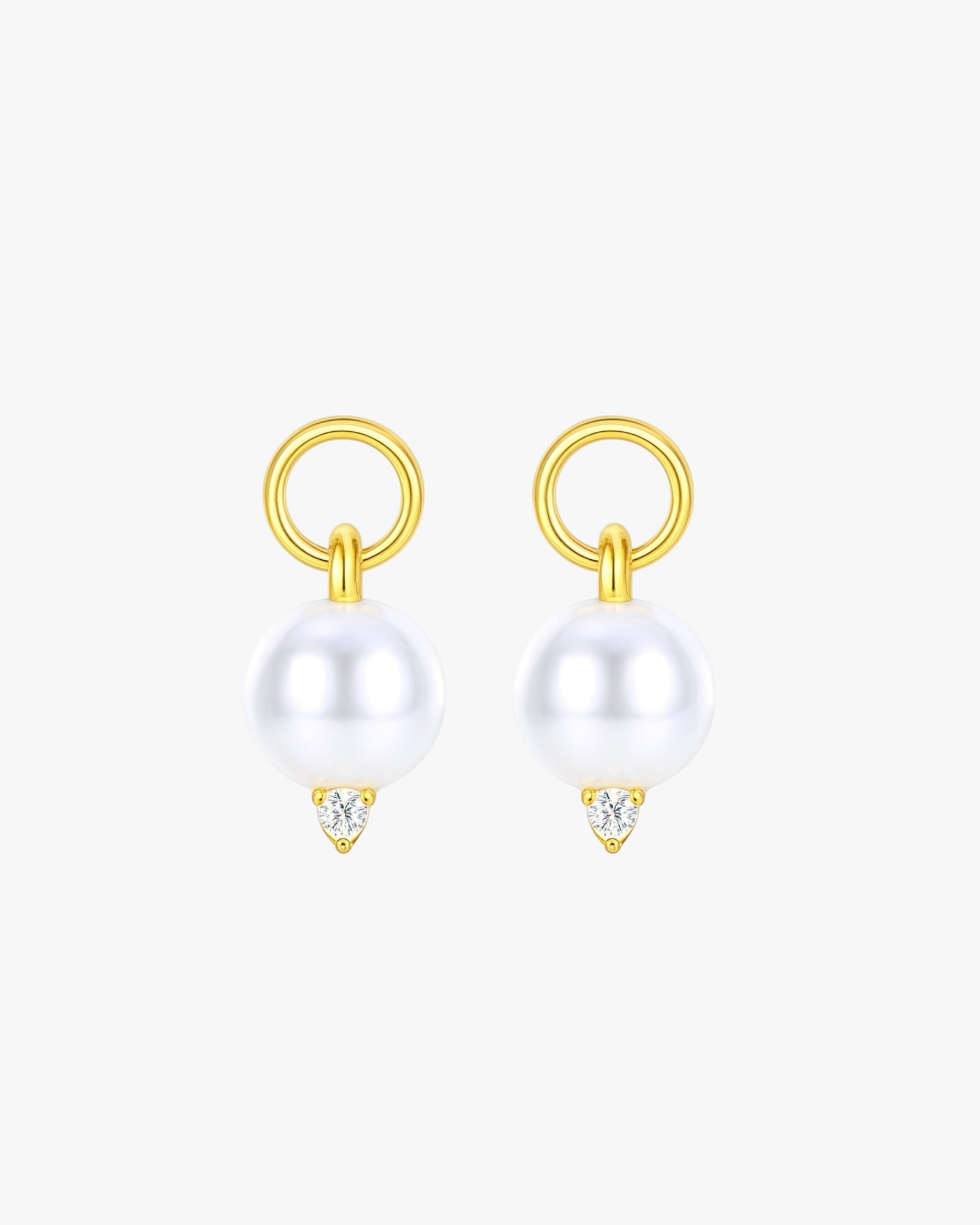 Gold earrings with pearls and small diamonds on a white background