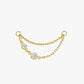 Gold chain with three clear gemstones on a white background