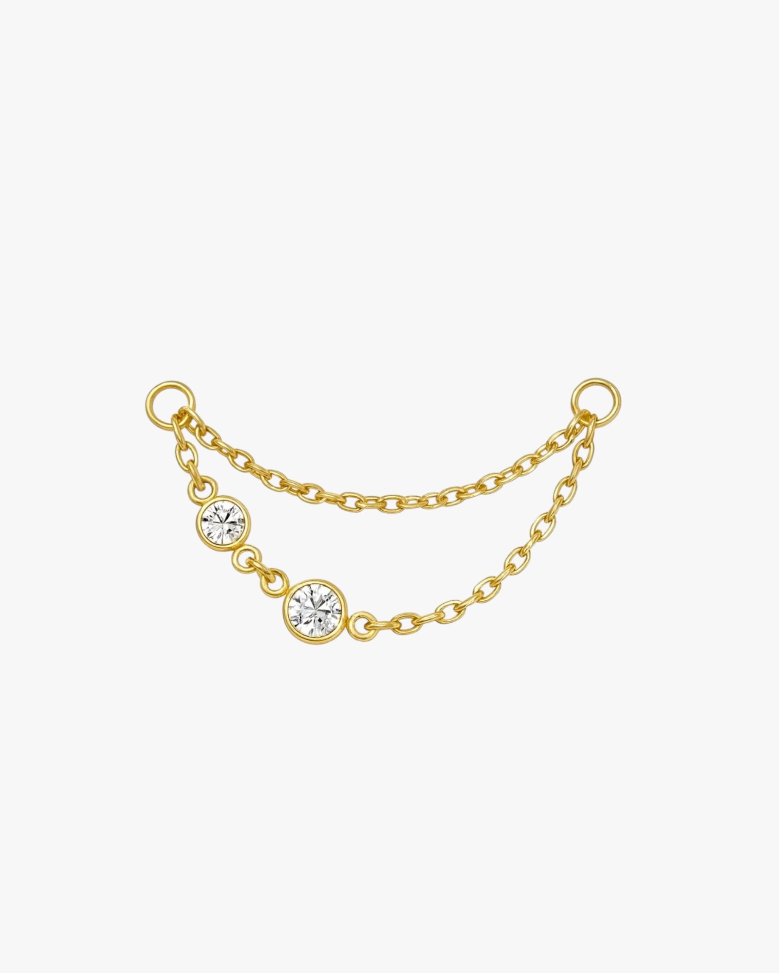 Gold chain with three clear gemstones on a white background