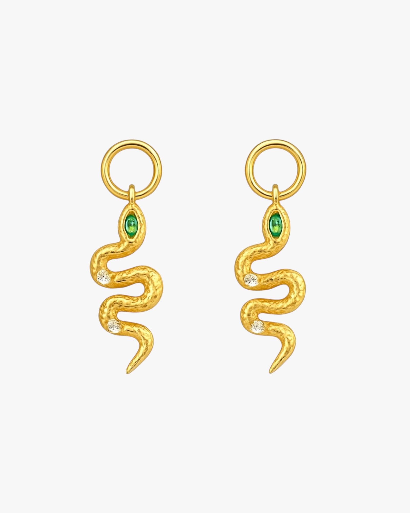 Gold snake-shaped earrings with green gemstones on a white background