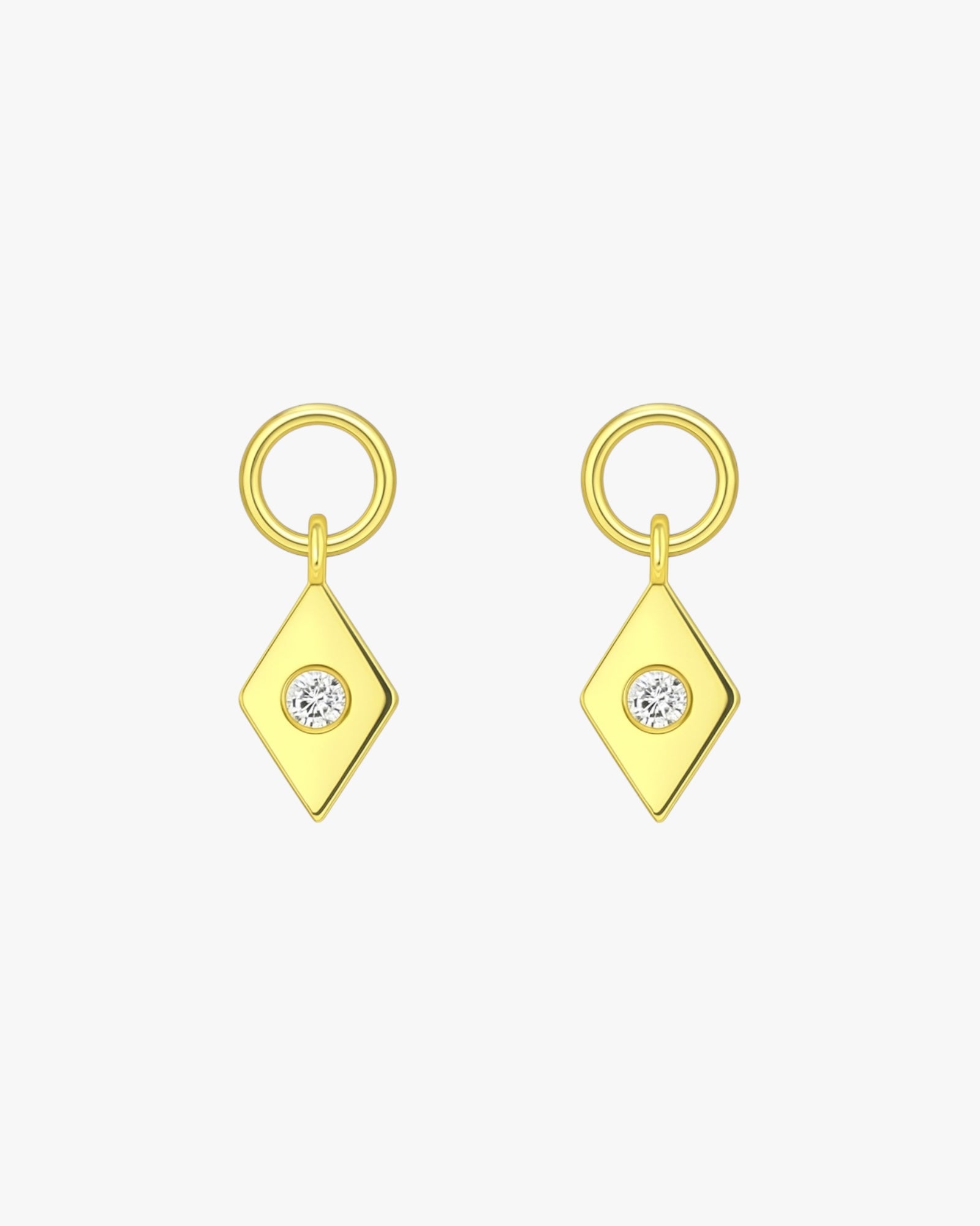 Pair of gold earrings with diamond-shaped pendants on a white background