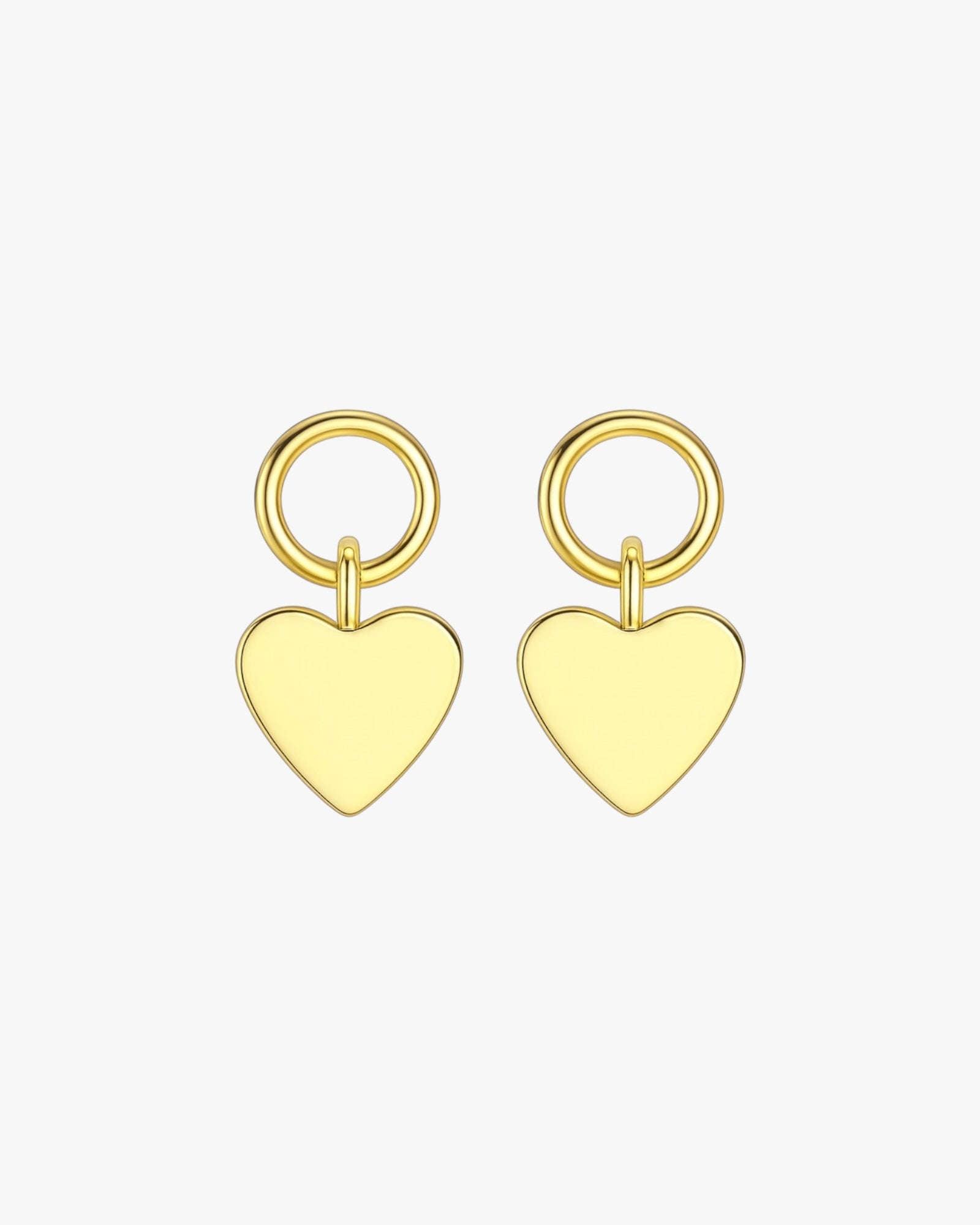 Gold heart-shaped earrings on a white background
