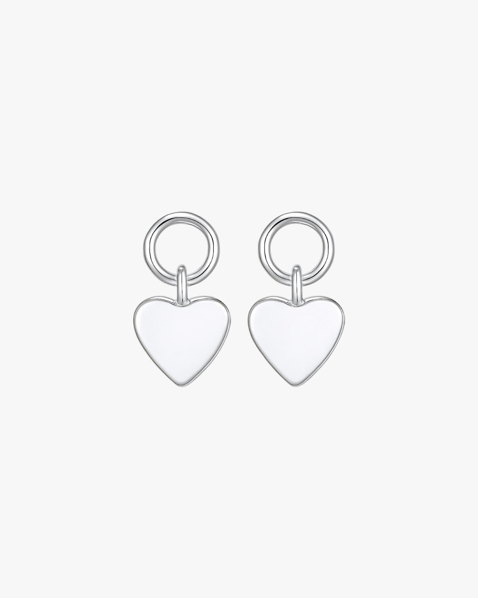 Pair of silver heart-shaped earrings on a white background