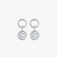 Pair of silver earrings with round gemstones on a white background