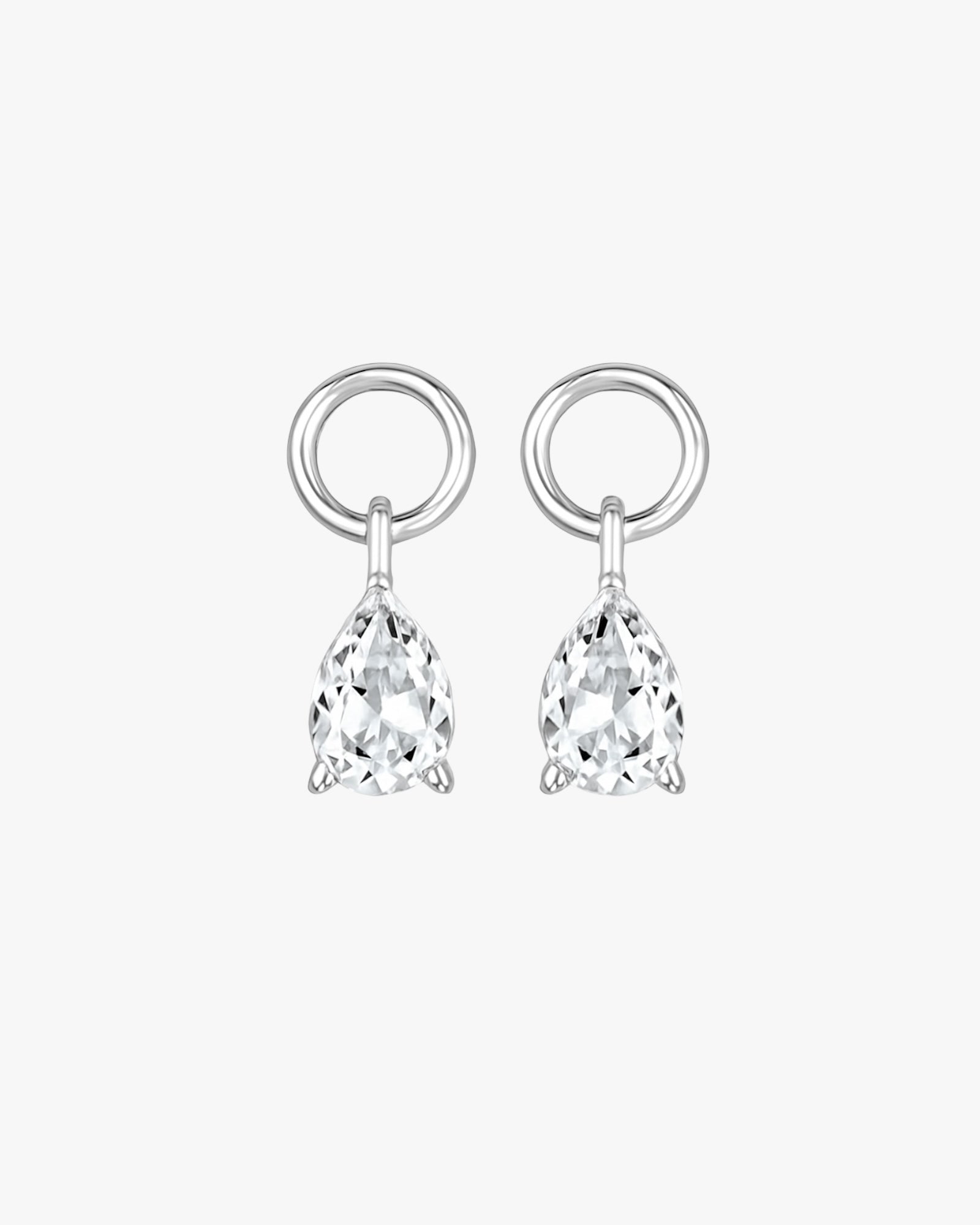 Pair of silver earrings with teardrop-shaped clear gemstones on a white background