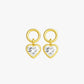 Gold heart-shaped earrings with clear gemstones on a light gray background