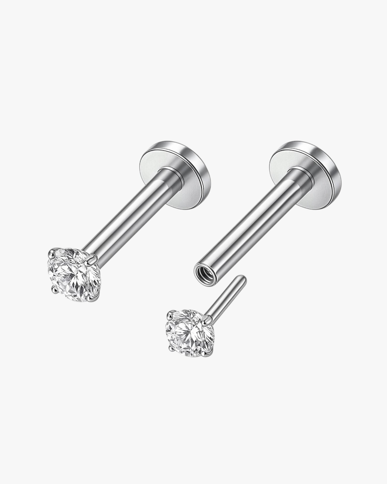 Pair of silver stud earrings with clear gemstones on a white background
