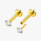 Gold barbell earrings with clear gemstones on a white background