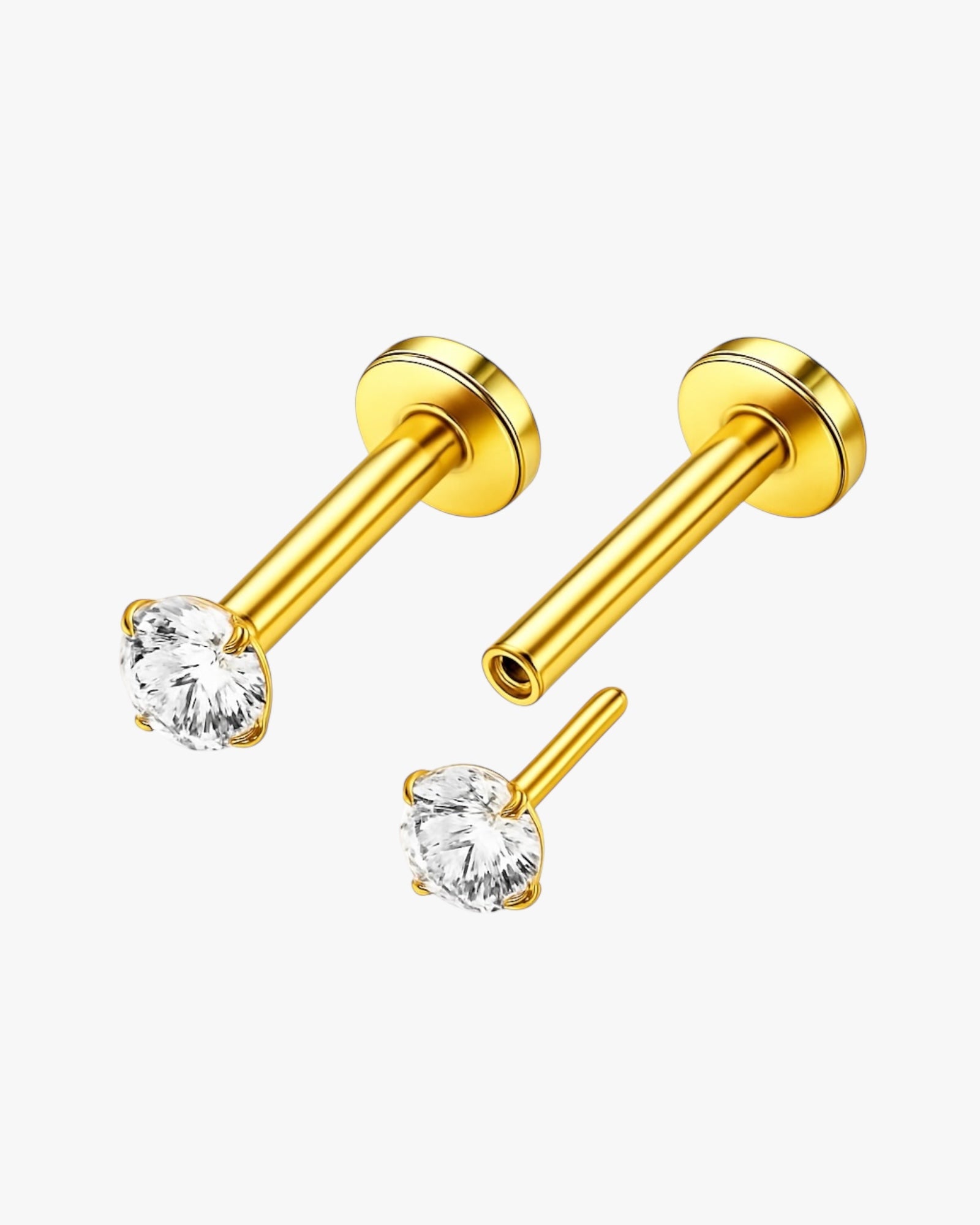 Gold barbell earrings with clear gemstones on a white background