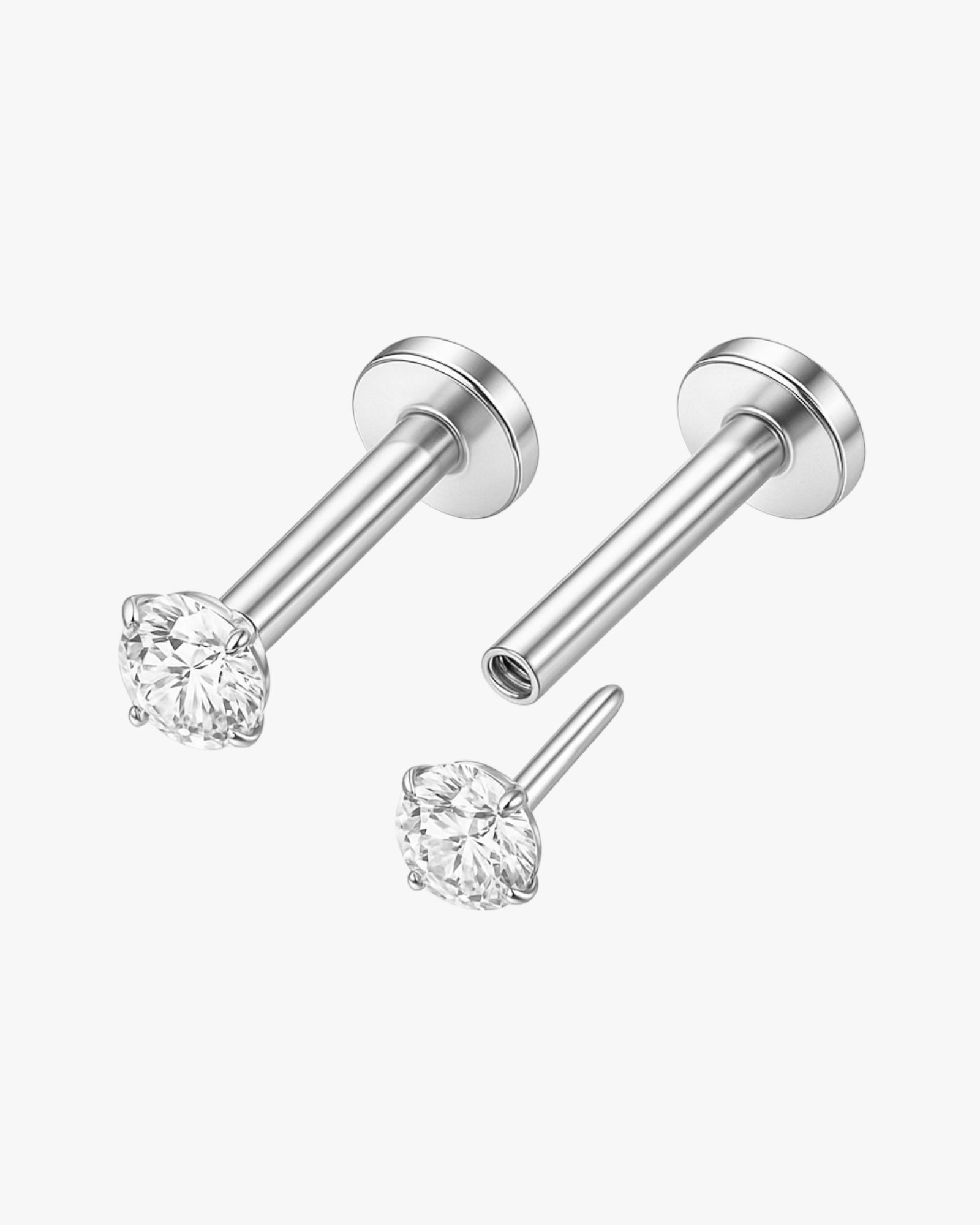 Pair of silver stud earrings with clear gemstones on a white background