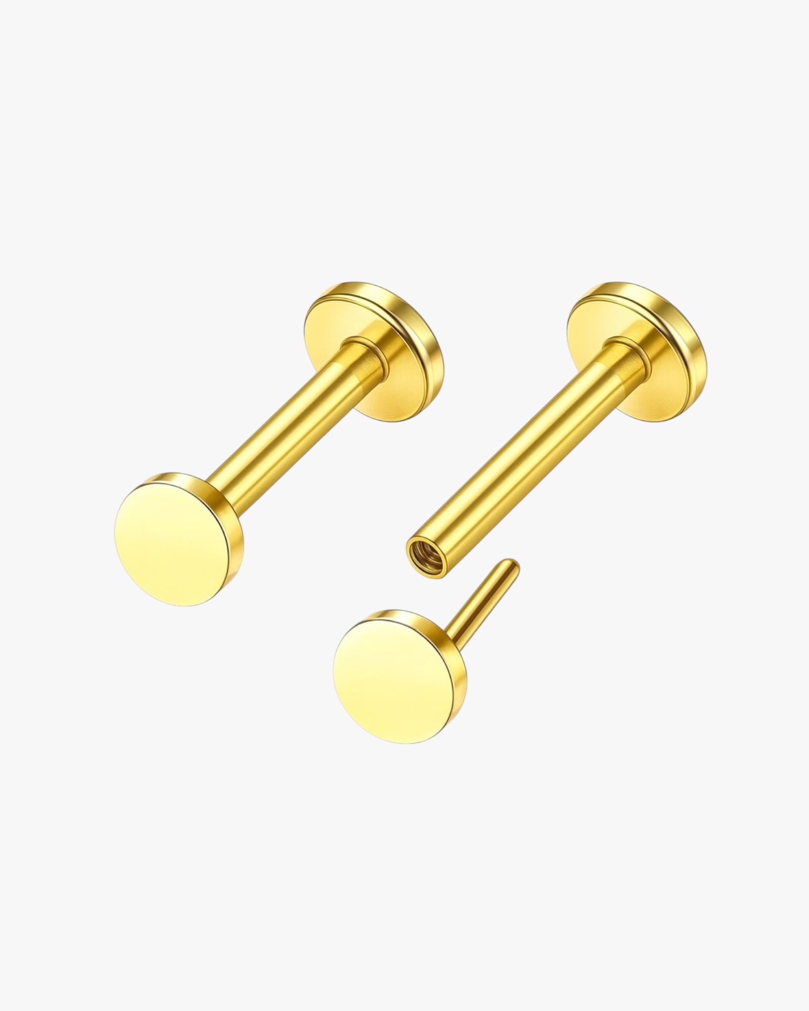 Gold stud earrings on a white background